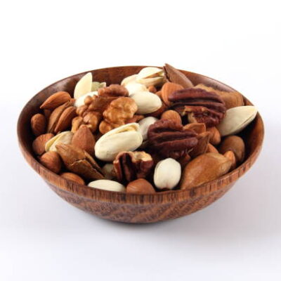 Wooden bowl with mixed nuts on white background