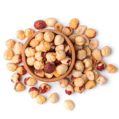 Hazelnut kernels in a wooden bowl isolated on a white background. top view