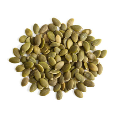 Isolated uncooked green pumpkin seeds on a white background from above.